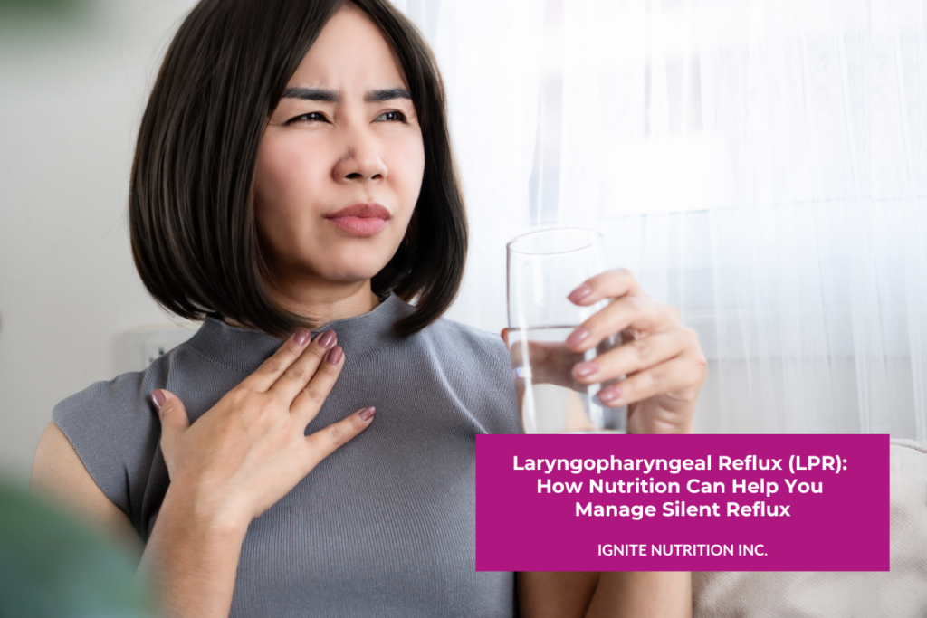 A woman holding a glass of water in one hand and rubbing her throat with the other hand, with a pained expression on her face.