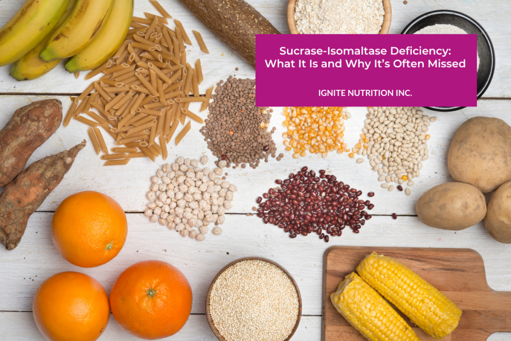 several starch foods are scattered on a wooden table including bananas, pasta, oranges, corn, potatoes, and flour
