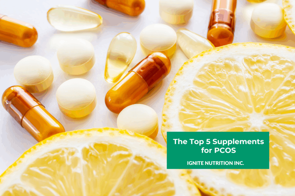 Two lemon slices sitting on a white tabletop next to a mix of different loose supplements